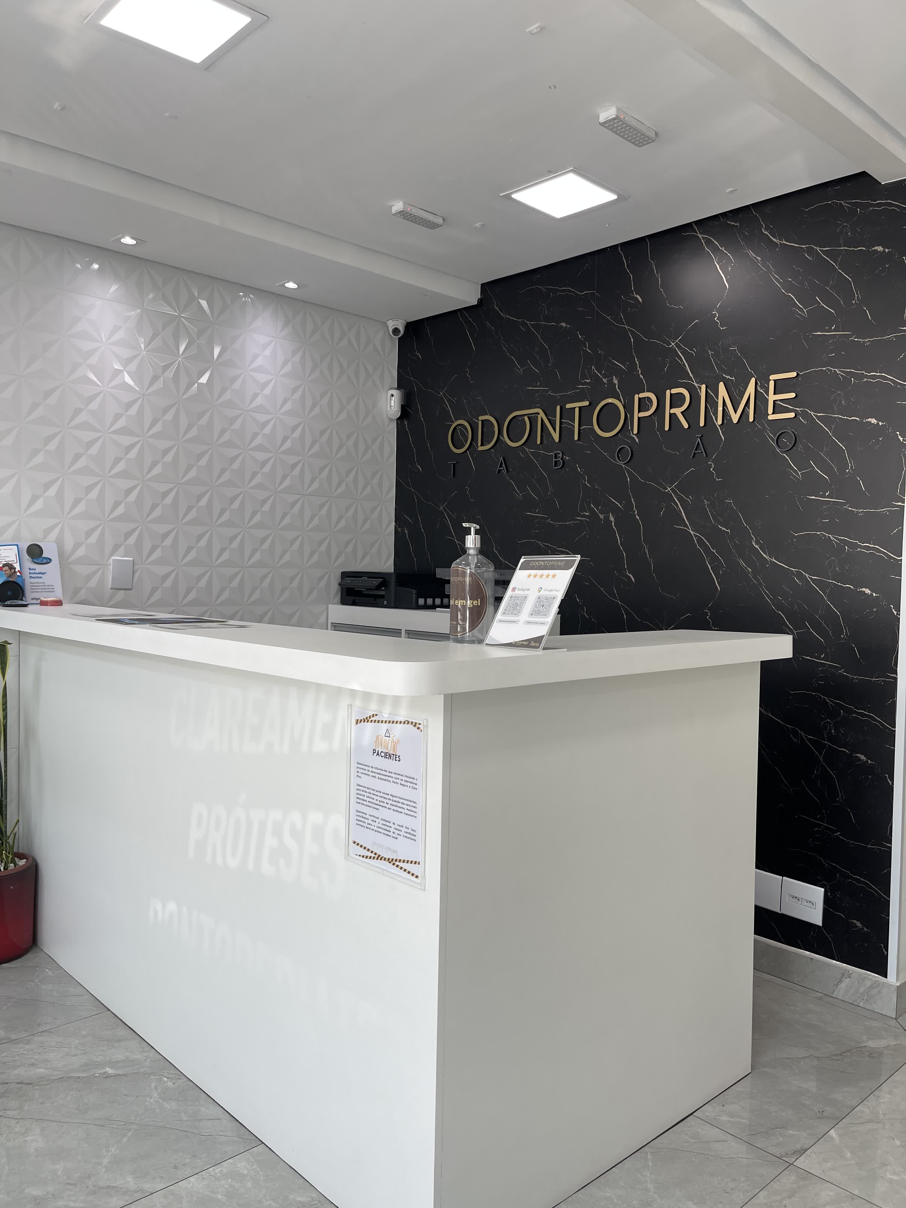 Balcão de recepção da Odonto Prime com logo dourado em destaque